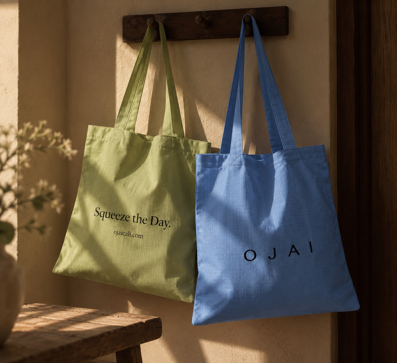 The Ojai market tote in green and blue, hanging on a peg rail